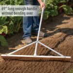 The landscape rake in action, spreading gravel on a lawn using the powerful garden tools design.